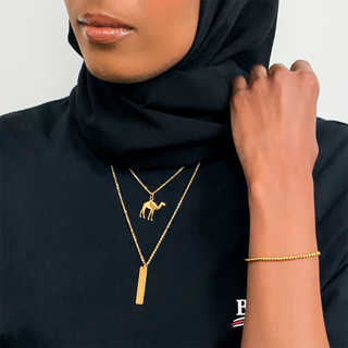 Model wearing the Camel Necklace, a meaningful Islamic jewelry piece symbolizing trust in God